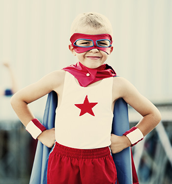 Boy wearing superhero costume before his appointment with a children’s dentist in Burlington, KY.” width=