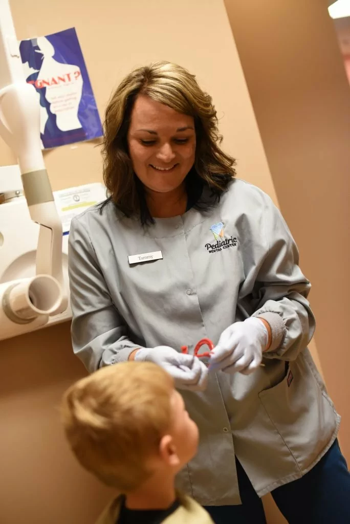 Kids' dentist in Burlington, KY helps clean a Northern Kentucky boy's baby teeth.