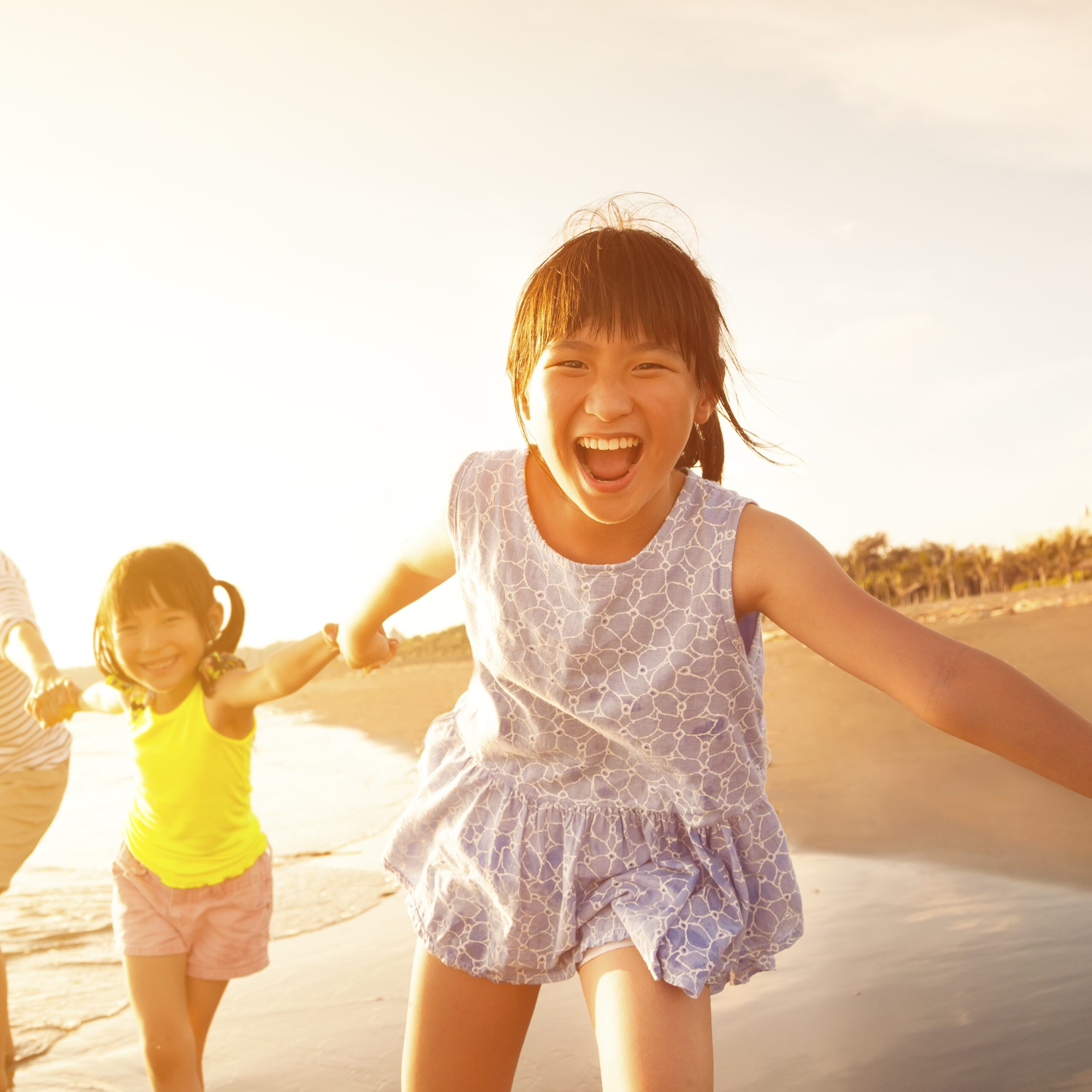 happy family running on the beach